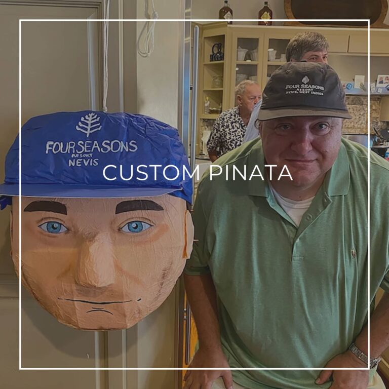 man standing next to a custom pinata of himself
