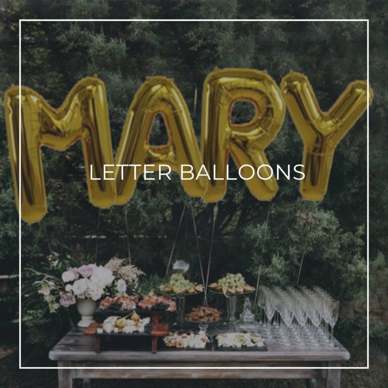 retirement party giant letter balloons spelling MARY above a party food table
