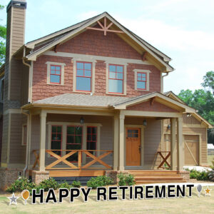 happy retirement spelled out in a yard card in front of house