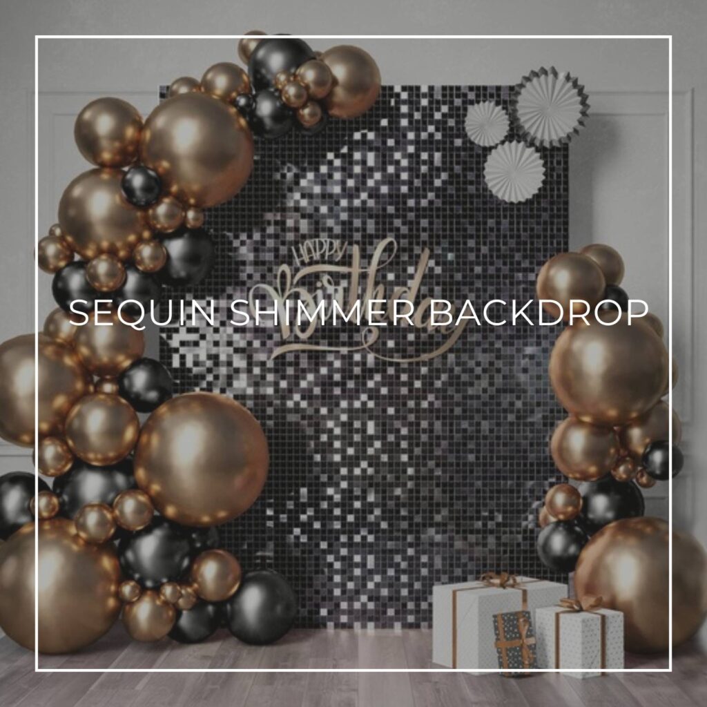 black sequin shimmer birthday backdrop surrounded by a black and gold balloon garland