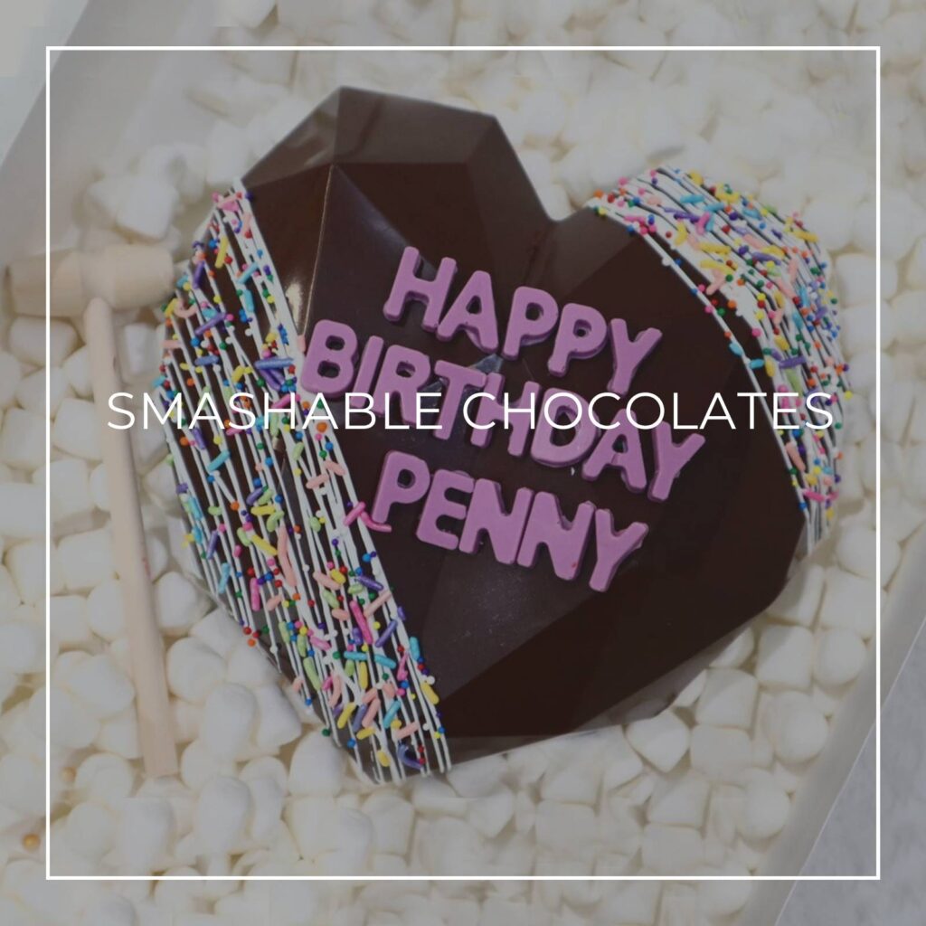 Happy Birthday Penny smashable chocolate heart with hammer on a bed of mini marshmallows