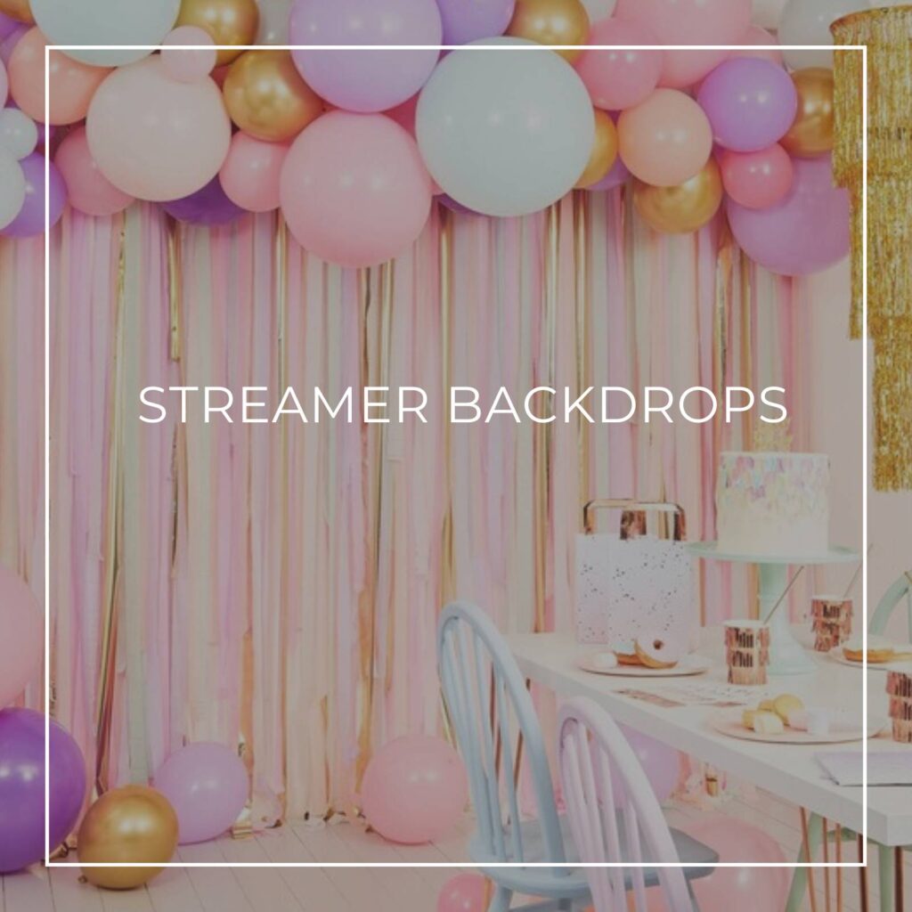 pastel colored streamer backdrop to a party table with balloons above