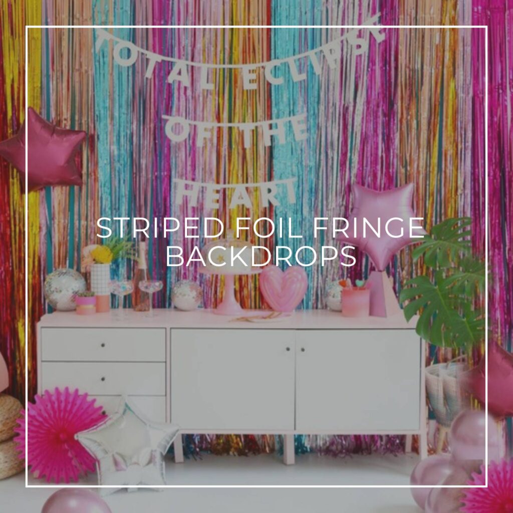 colorful striped foil fringe curtain backdrop behind a party table