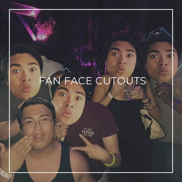 group of people holding custom fan faces of the guest of honor in front of their own faces at a surprise party