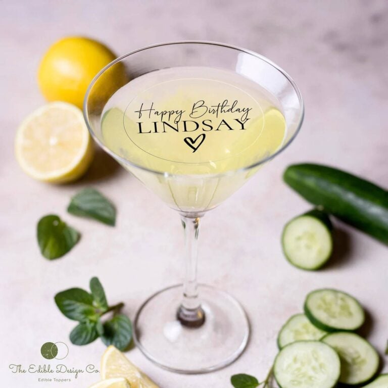 Edible text topper reading "Happy Birthday Lindsay" on a clear martini