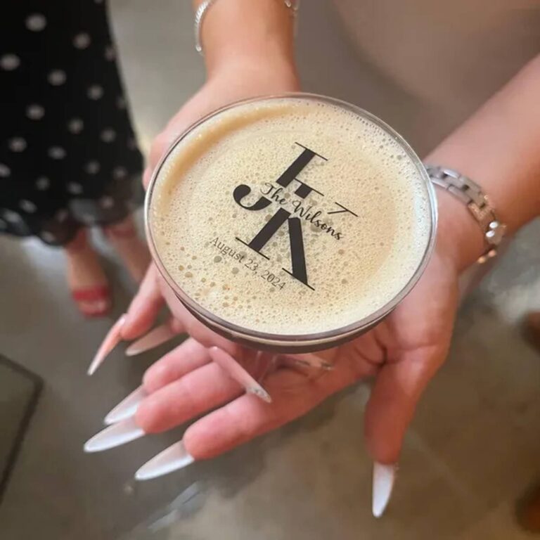 Edible monogram topper reading "JK, The Wilsons, August 23 2024" on a foam-topped drink